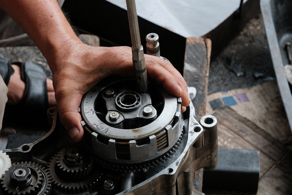 mechanic assembling a dirt bike clutch